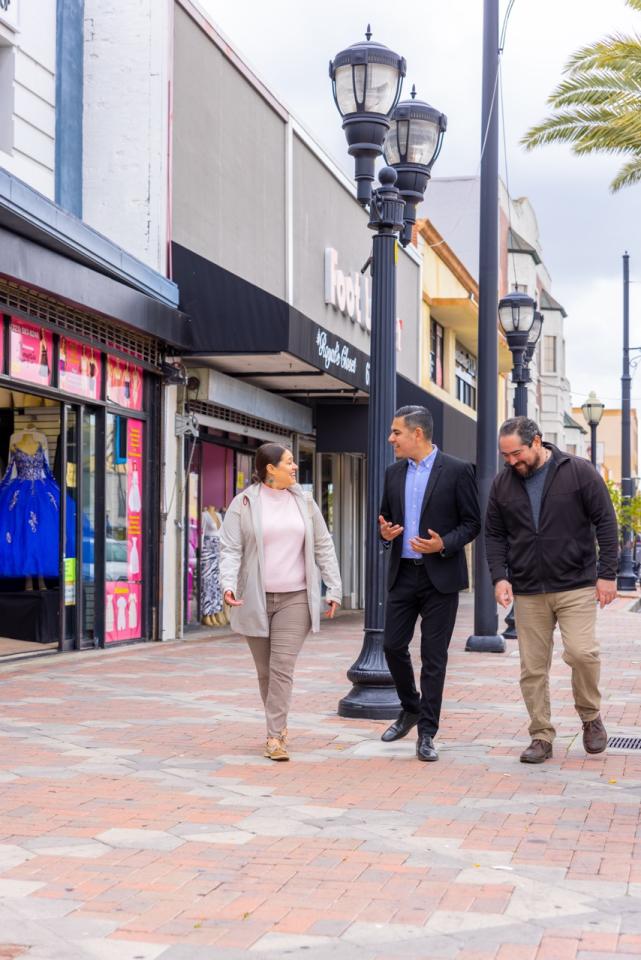 Congressman Garcia talking while walking with a constituent 