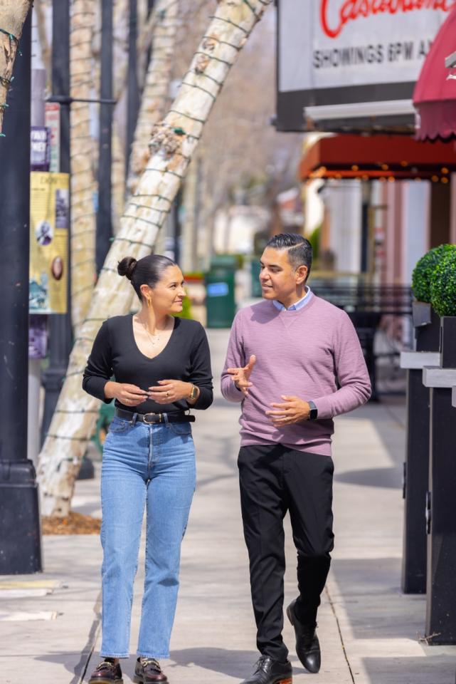 Congressman Garcia walking and talking to a constituent 